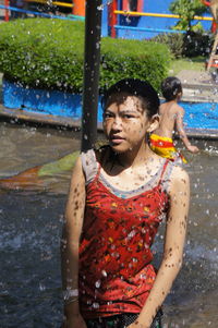 Portrait of teenage girl standing at fountain