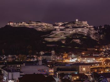 High angle view of illuminated buildings in city at night