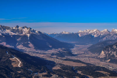 Scenic view of mountains against blue sky