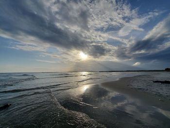 Scenic view of beach against sky during sunset