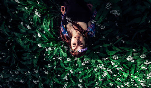 Portrait of woman lying on plants