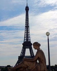 Female statue against eiffel tower