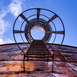 Low angle view of ladder against blue sky