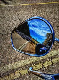 Close-up of side-view mirror on street