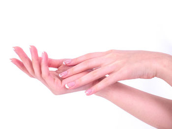Close-up of hands over white background