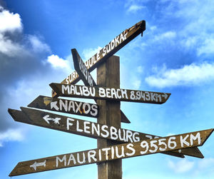 Low angle view of road sign against sky