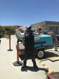 Full length of man standing against blue sky