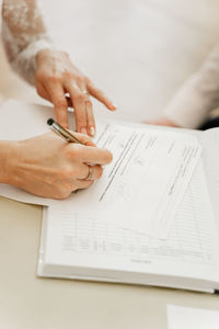 Woman signing on paper