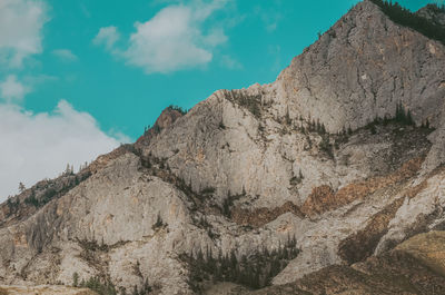 Low angle view of rocky mountains against sky