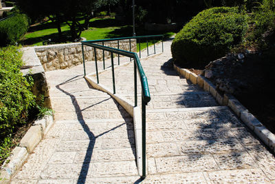 High angle view of footpath by railing in park