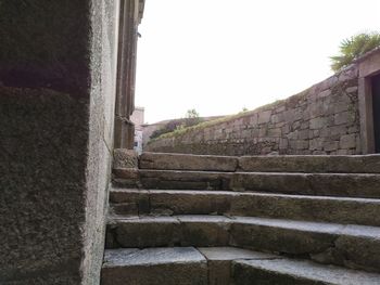 Low angle view of staircase by building against clear sky