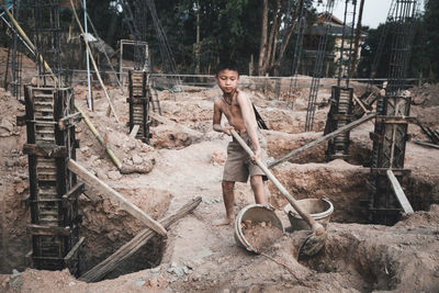 Portrait of a young man standing at construction site