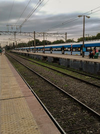 Train at railroad station against sky