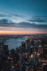 Illuminated cityscape against sky