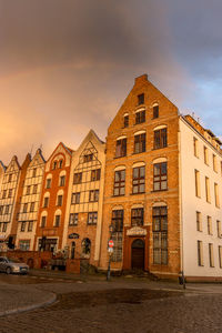 Buildings against sky at sunset