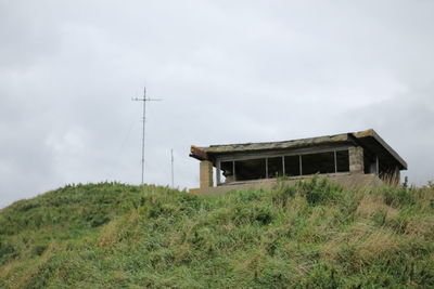 Low angle view of building on field against sky