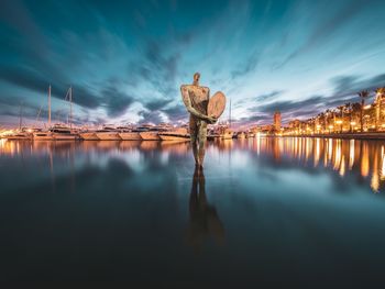 Panoramic view of illuminated sea against sky at night