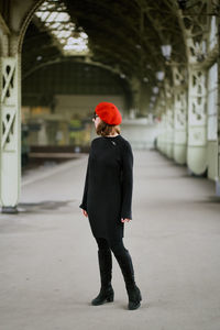 Full length rear view of woman walking in building