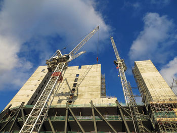 Low angle view of crane against sky