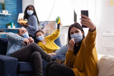 People wearing mask doing selfie at home