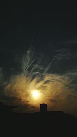 Low angle view of silhouette building against sky