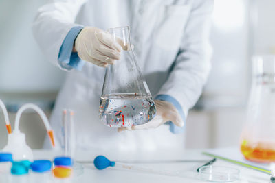 Scientist examining microplastic particles in a water sample