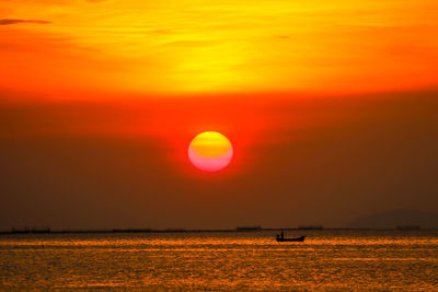 Scenic view of sea against romantic sky at sunset