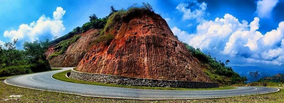 sky, cloud - sky, cloud, mountain, rock formation, tranquility, tree, blue, tranquil scene, nature, scenics, beauty in nature, transportation, sunlight, rock - object, road, non-urban scene, landscape, day, panoramic