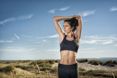 Woman stretching and keeping fit at the beach