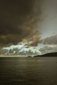 Scenic view of sea against storm clouds