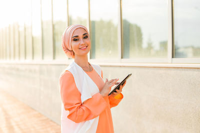 Portrait of young woman using mobile phone