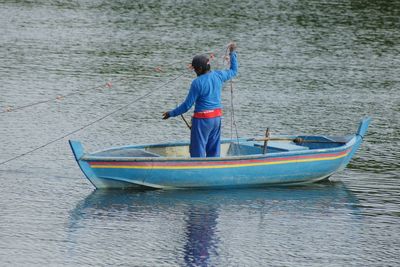 Rear view of man standing in sea