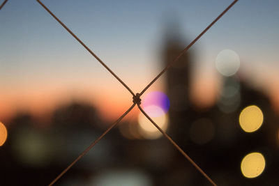 Close-up of silhouette fence against sky during sunset