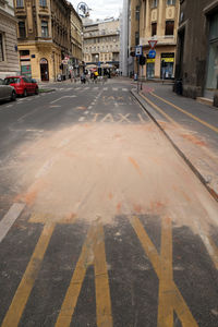 Surface level of street amidst buildings in city