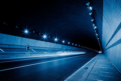 View of illuminated tunnel at night