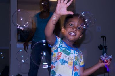 Portrait of happy girl standing at home
