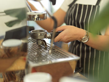 Midsection of woman having coffee