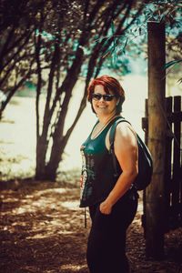 Portrait of young woman wearing sunglasses standing outdoors