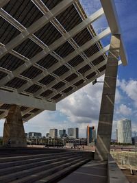 Modern buildings against cloudy sky