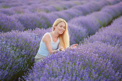 Portrait of young woman standing on field