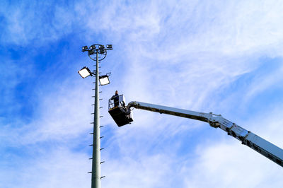 Low angle view of floodlight against blue sky