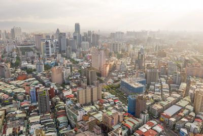 High angle view of modern buildings in city against sky