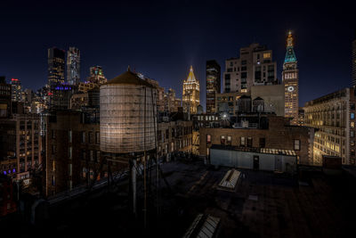 Illuminated buildings in manhattan at night