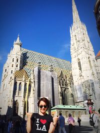 Portrait of happy young woman in front of st stephens cathedral