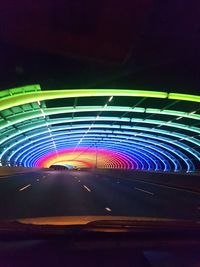 Light trails against blue sky at night