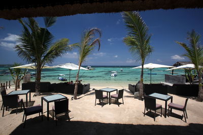 Chairs and tables at outdoor cafe on beach