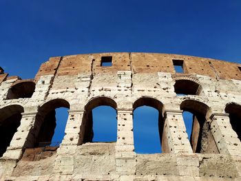 Low angle view of old building against blue sky