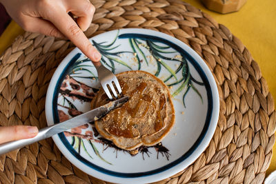 High angle view of person holding breakfast on table