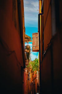 Buildings against sky seen through window