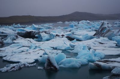 Scenic view of frozen lake against sky